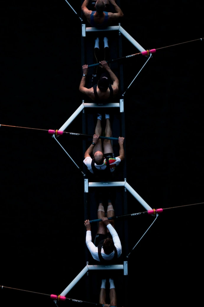 five men riding row boat