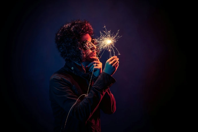 man in black jacket holding spark