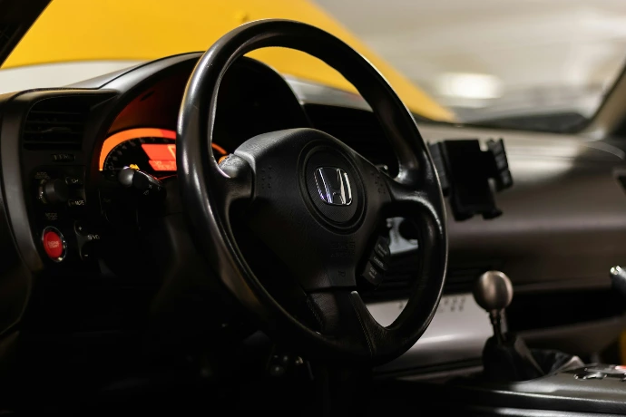 a close up of a steering wheel and dashboard of a car